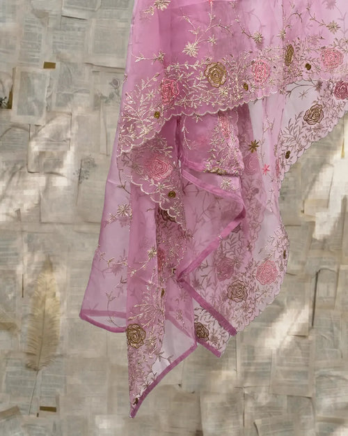 Pink embroidered fabric draped